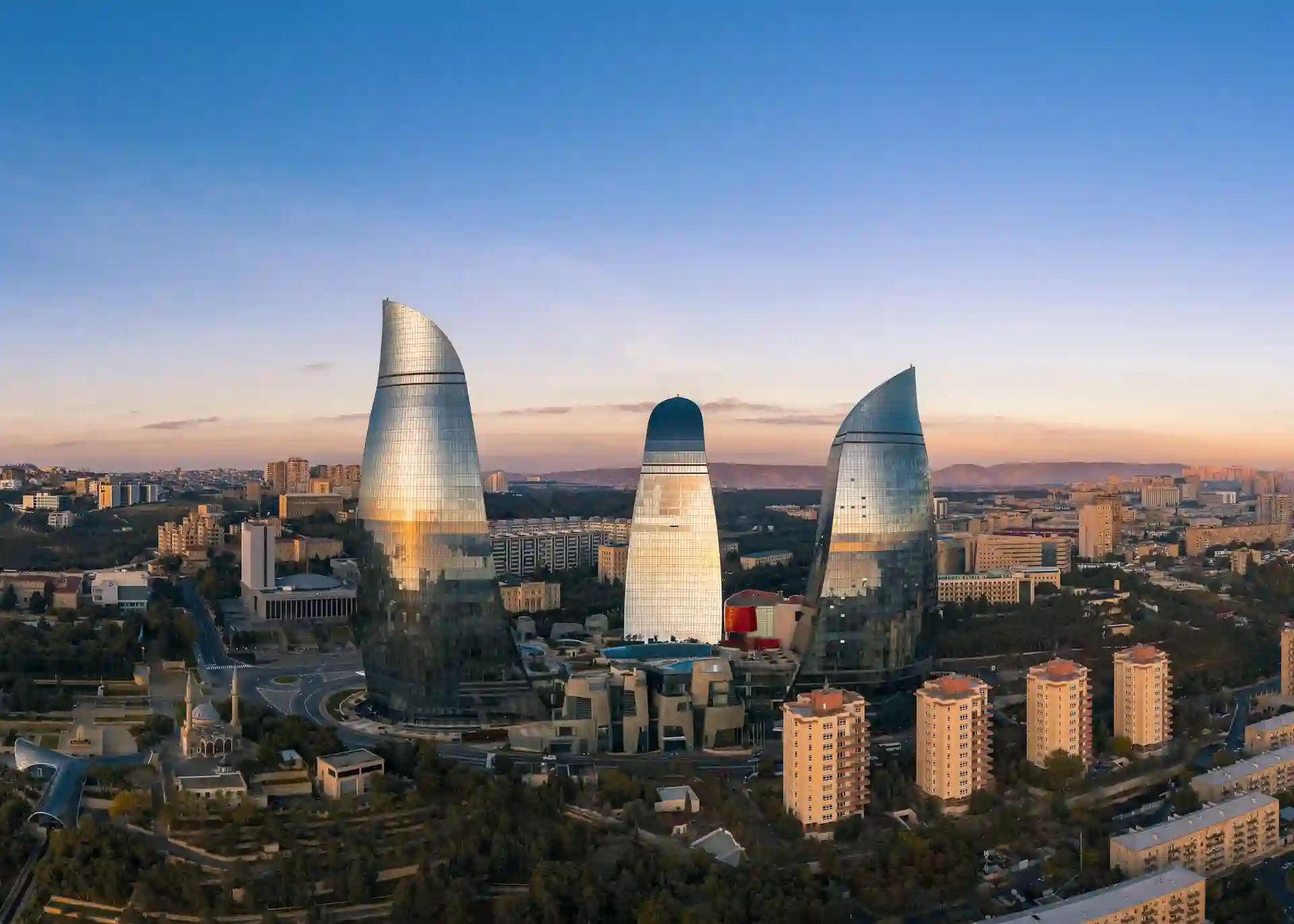 Travel guide to Azerbaijan featuring the iconic Flame Towers illuminated over Baku Boulevard and the Caspian waterfront