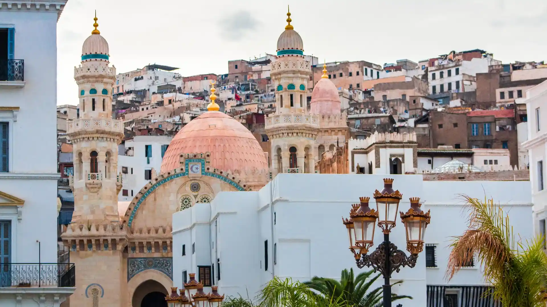 Travel guide to Algeria featuring white-walled Mediterranean architecture and historic minarets in the Casbah of Algiers