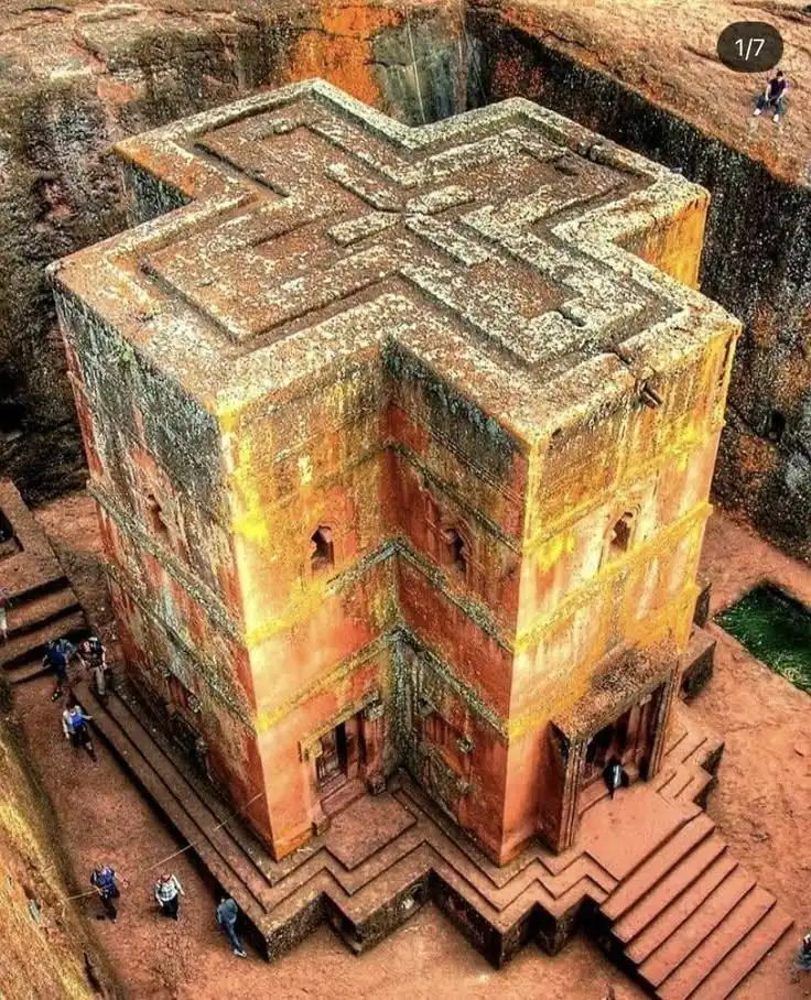 Travel guide to Ethiopia featuring the rock-hewn Church of Saint George (Biete Ghiorgis) carved into reddish volcanic tuff in Lalibela