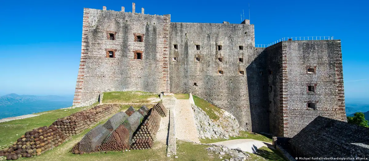 Travel guide to Haiti featuring the majestic Citadelle Laferrière fortress perched atop a mountain in Cap-Haïtien