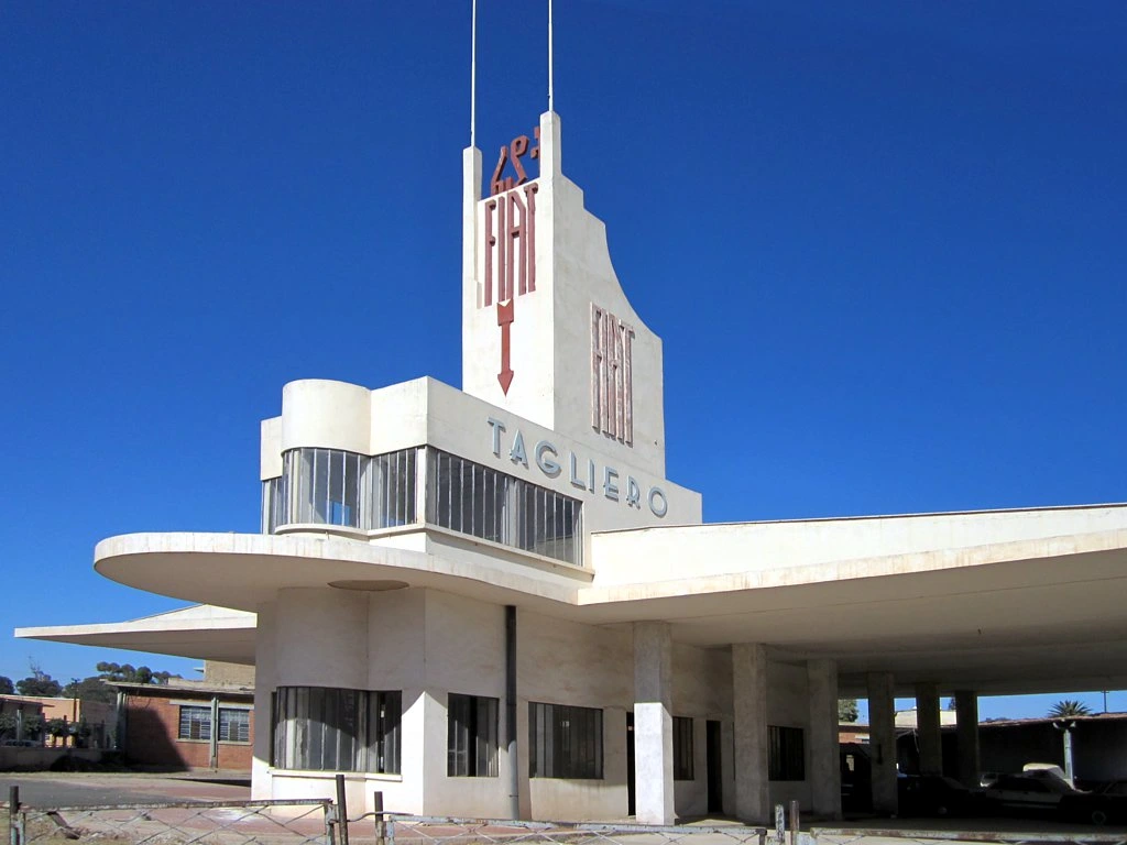 Travel guide to Eritrea featuring the iconic Fiat Tagliero Futurist service station building with airplane-shaped wings in Asmara