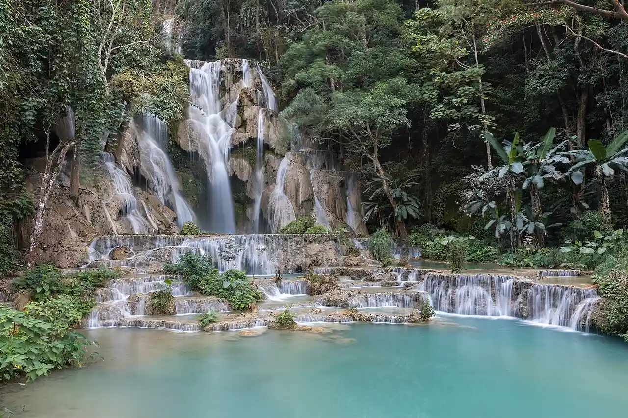 Travel guide to Laos featuring the vibrant turquoise pools of Kuang Si Waterfalls