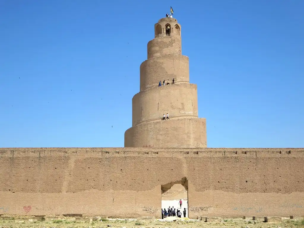 Travel guide to Iraq featuring the ancient Spiral Minaret of Samarra against a clear blue sky