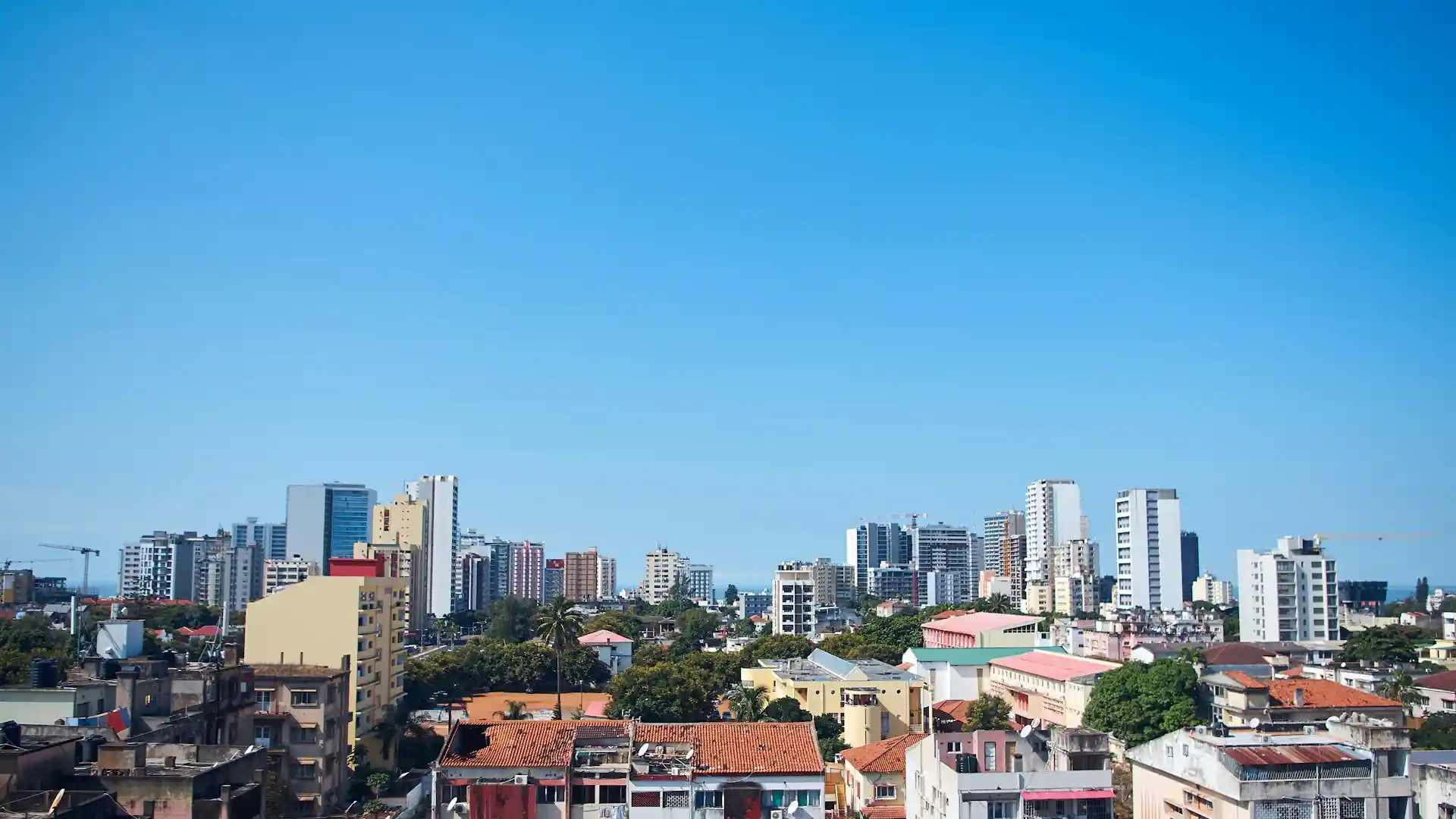 Travel guide to Mozambique featuring Maputo's skyline and the Indian Ocean coast