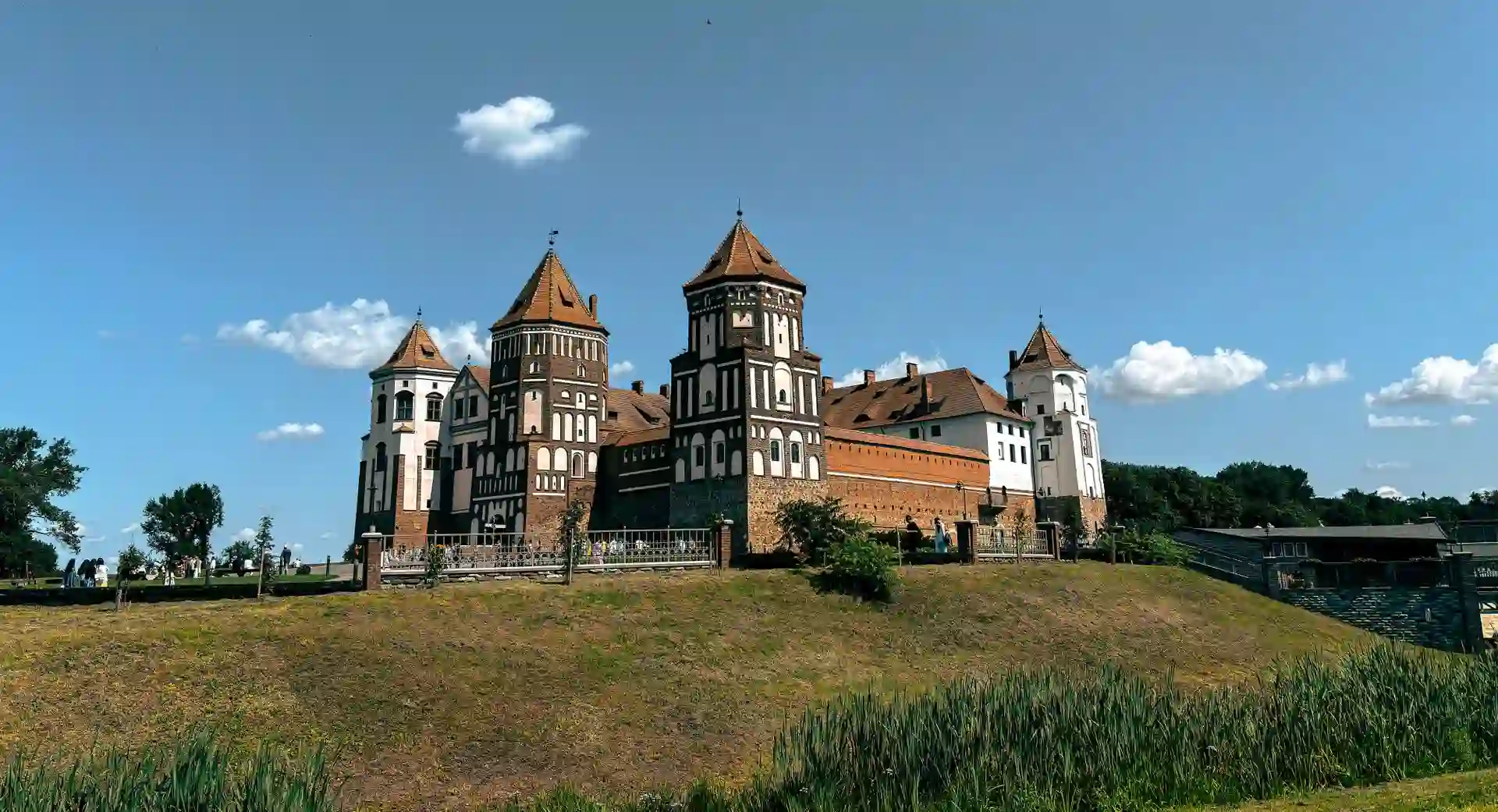 Travel guide to Belarus featuring the fairytale Mir Castle reflection across the lake