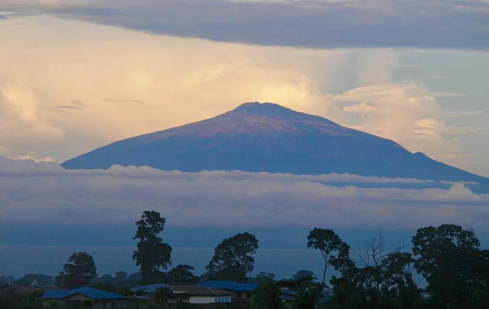 Travel guide to Cameroon featuring Mount Cameroon volcano towering over Buea