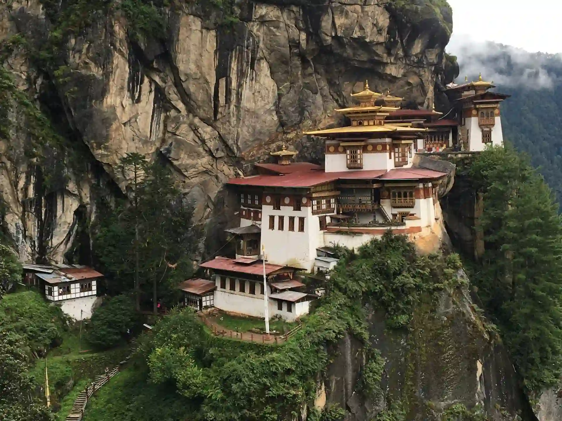 Travel guide to Bhutan featuring the sacred cliffside Paro Taktsang Tiger's Nest Monastery
