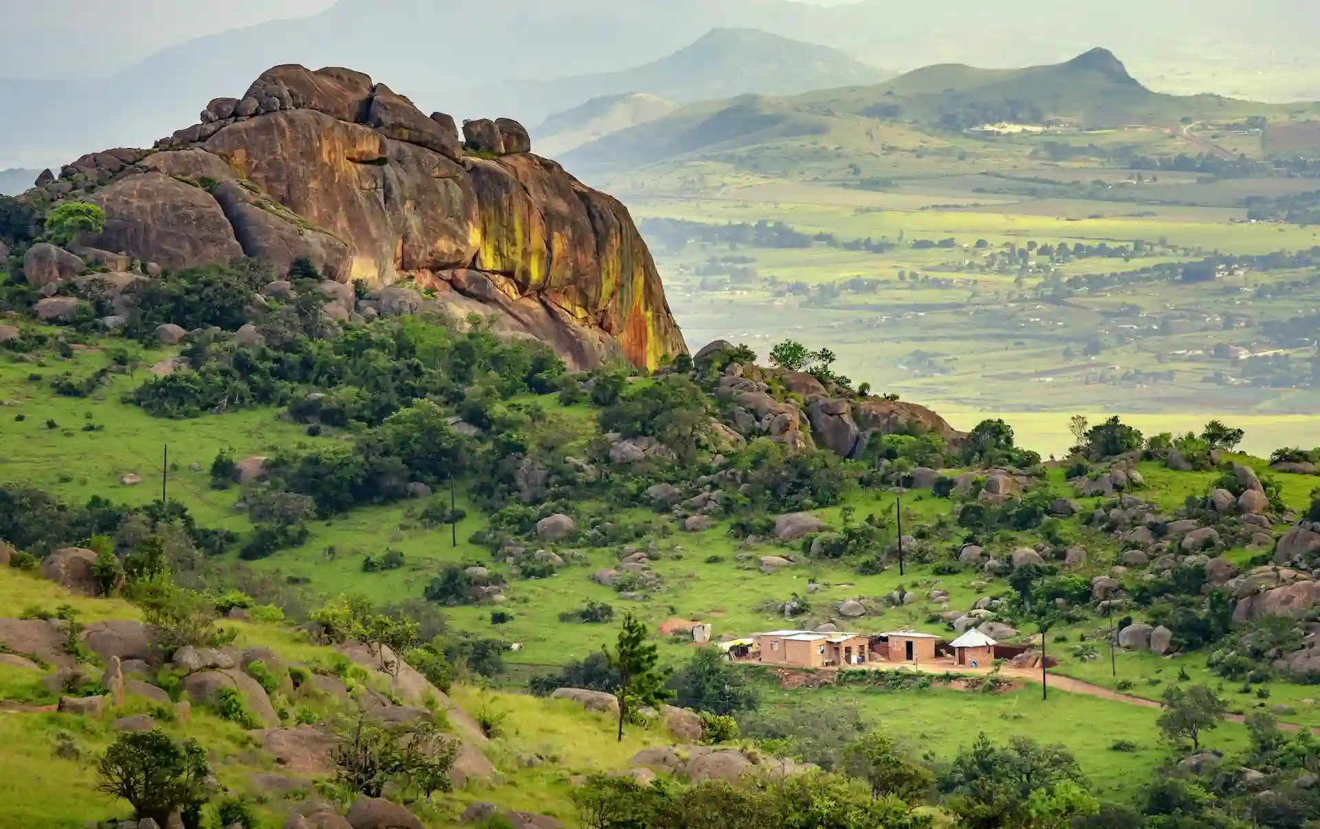 Travel guide to Eswatini featuring sweeping green mountains and wildlife in a protected nature reserve