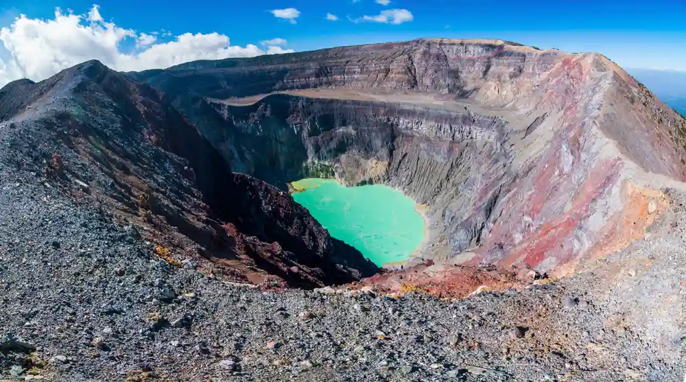 Travel guide to El Salvador featuring the turquoise crater lake atop the summit of Santa Ana Volcano (Ilamatepec) surrounded by volcanic peaks