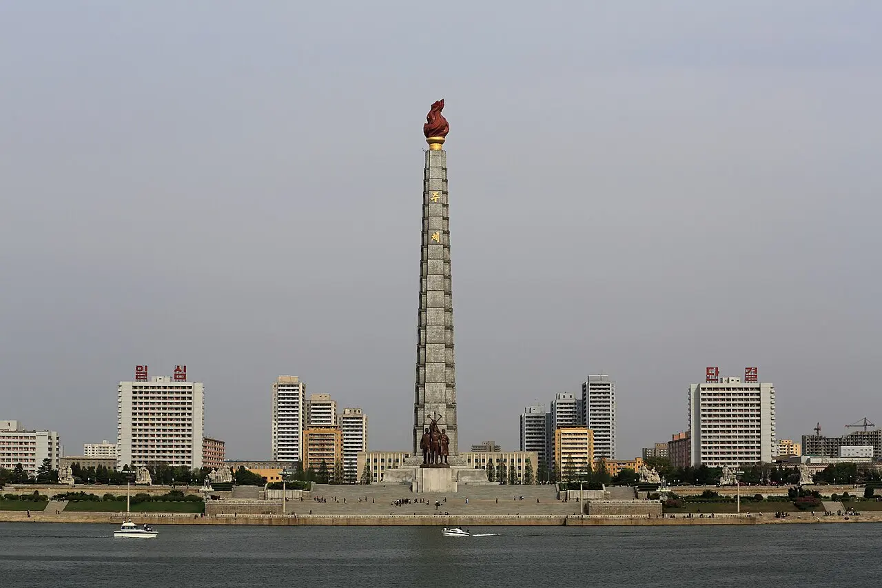 Travel guide to North Korea featuring Juche Tower along the Pyongyang skyline